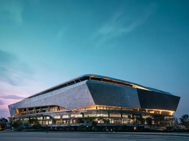 Sports arena cladding under evening lights